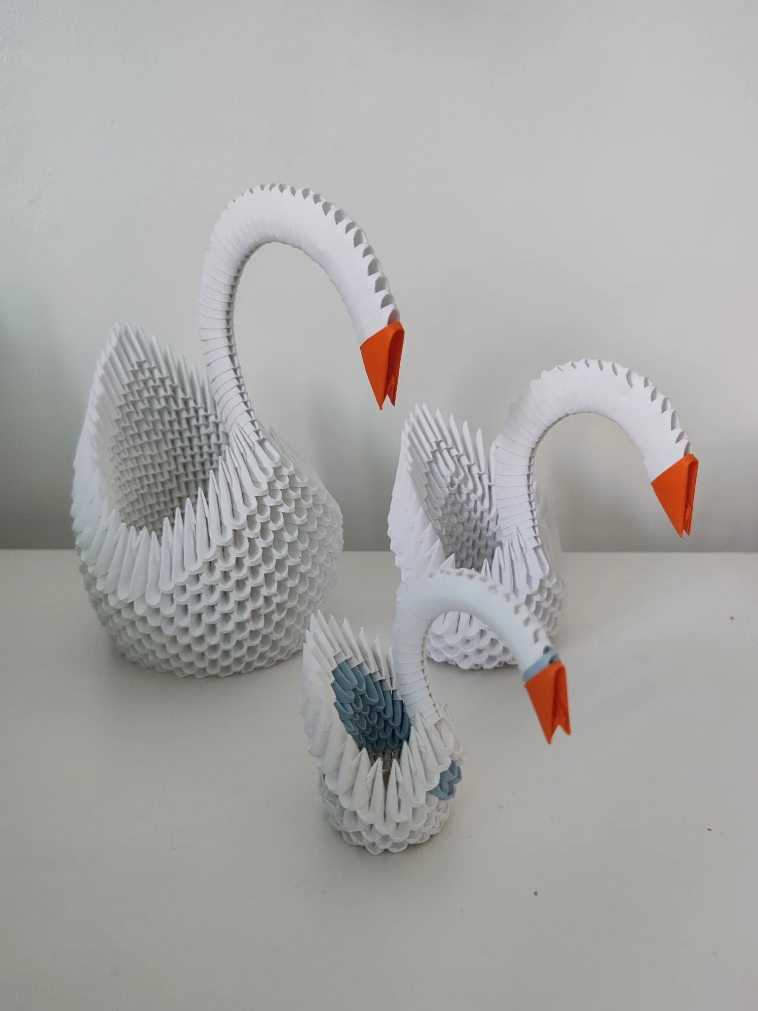 Les trois tailles de cygne origami 3D côte à côte